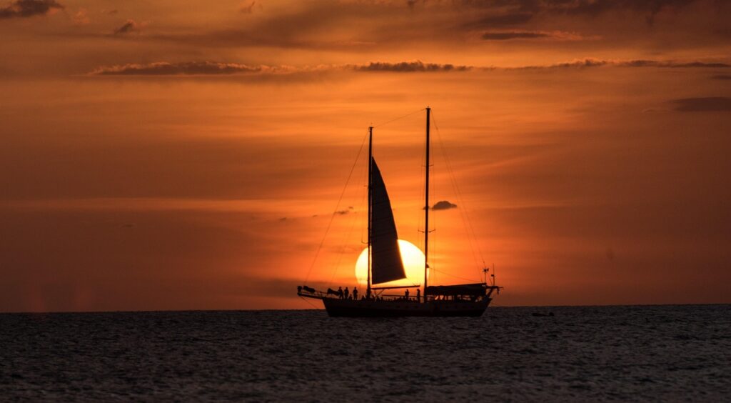 Sailboat at sunset on the Pacific Ocean in Costa Rica, symbolizing the relaxed and inspiring lifestyle of relocating abroad.